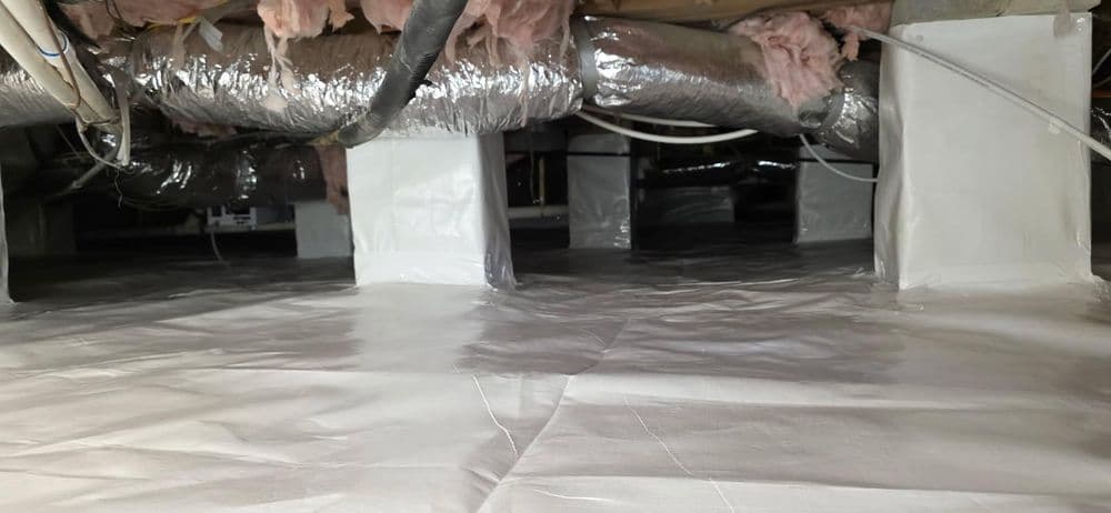 Crawl space with white plastic vapor barrier, exposed ductwork, and insulation above.